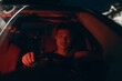 © Pansfun Images/Stocksy - Emotional man in car on rainy night.