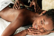 © David Prado/Stocksy - Relaxing hot stone massage at a wellness spa