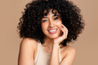 © mahalo studio/Stocksy - Radiant smile - curly haired woman portrait