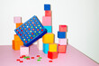© Colour Laboratory/Stocksy - Connect four game and geometry building blocks with hard flashlight