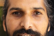 © Wavebreak Media - Close-up of Indian male face with beard and mustache, looking directly ahead