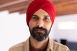 © Wavebreak Media - Portrait of Indian man wearing red turban, looking confidently at camera