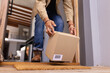 © Wavebreak Media - Receiving package delivery, man picking up cardboard box from doorstep