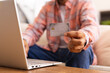 © Wavebreak Media - Holding credit card, man using laptop for online shopping at home