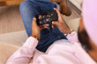 © Wavebreak Media - Using smartphone, man relaxing on couch and playing game at home