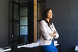 © Wavebreak Media - Standing confidently in office, businesswoman smiling and looking away