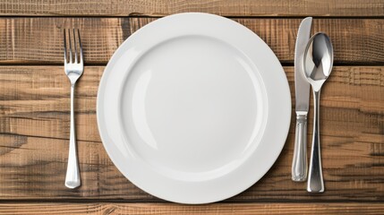 Top view of a clean plate with spoon, fork, and knife, wooden background, isolated with studio lighting, clear and high-quality for food display advertising