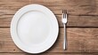 © Paul - Top view of an empty plate and cutlery, wooden background, isolated studio lighting, sharp and clear, ideal for food display and advertising