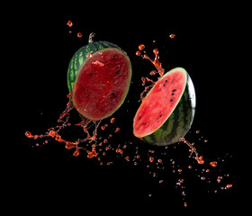 Wall Mural - sliced watermelon with watermelon juice splash on black background,stop motion
