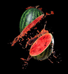 Wall Mural - sliced watermelon with watermelon juice splash on black background,stop motion