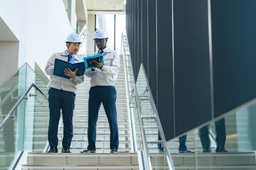 Poster - Group of multinational engineers having a conversation in a facility