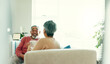 © CoetzeeRising/peopleimages.com - Tea time, happy and elderly couple in living room for love, story telling and bonding at home. Senior man, woman and relax on sofa with talking, nostalgia and commitment or support in retirement