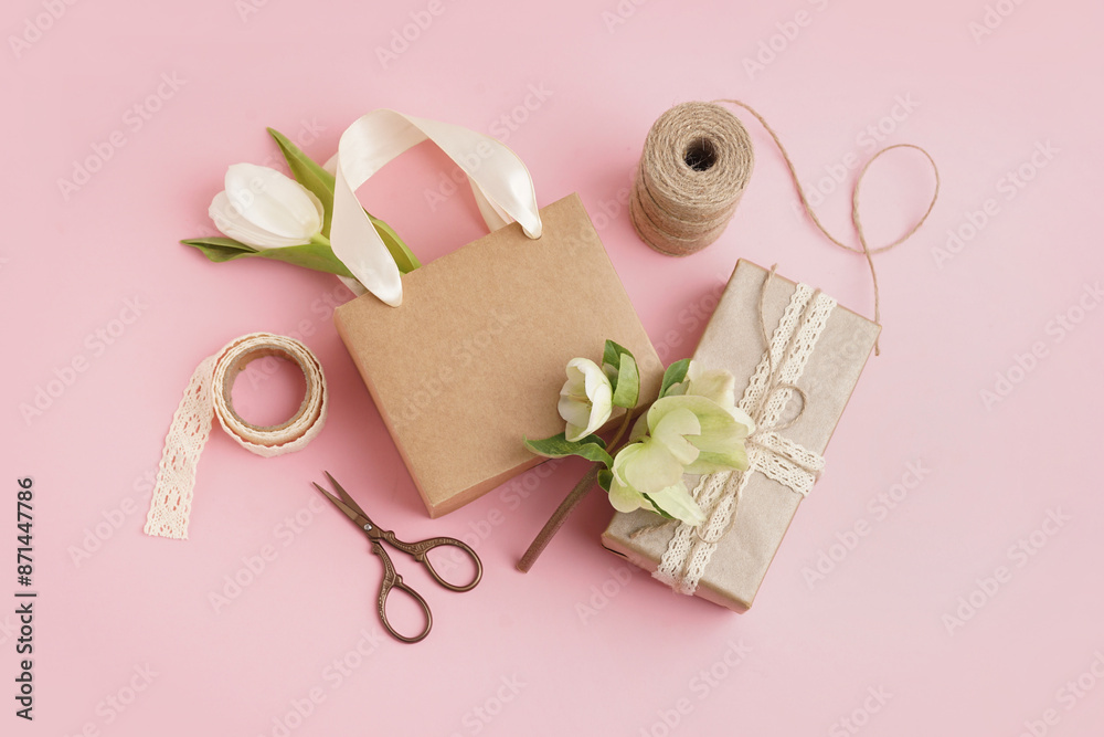 Gift boxes with beautiful flowers on pink background