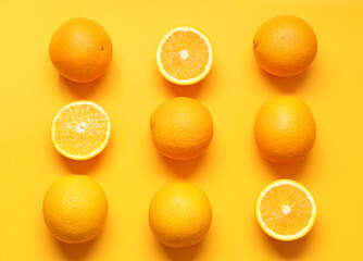 Composition with ripe tasty oranges on orange background