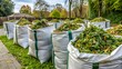 © Alon - Big white bags filled with organic green garden waste after gardening. Local councils collecting green waste to process it into green energy and compost.