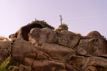 Wall Mural - A rocky hillside with a power line running through it