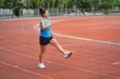 © chachamp - Asia mature woman Runner drill training on race track and field