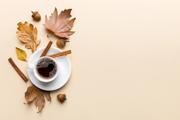 Wall Mural - Flat lay composition with colorful Autumn cup of coffee and leaves on a color background. top view