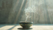 © SashaMagic - Incense burning in a bowl with sun rays illuminating the smoke.