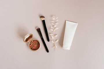 Makeup kit with a brush, a tube of foundation and a compact mirror