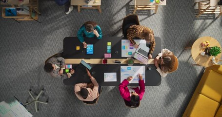 Fototapete - Top Down View of Young, Diverse Entrepreneurs in a Colorful Office, Solving Problems and Designing Software, Using laptop, Tablets, and Creative New Project at Conference Table. Productive Teamwork