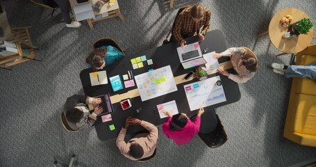 Fototapete - Top Down View: Diverse Team of Entrepreneurs Working on Digital Marketing Strategy. Businesspeople Analyze Data, Discuss Ideas and Use Laptops in Office. Creative Workspace With Charts, Infographics.