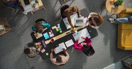 Aufkleber - Top Down View of a Team Meeting in a Conference Room of a Technological Startup Office, Working on Laptops and Tablets, Analyzing Financial Charts and Graphs. Innovation in a Workspace Concept.