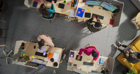 Leinwandbilder - Zoom Out Top Down View: Diverse Team of Professionals Working in a Office. Businesspeople Analyze Data, Managing Projects, and Use Desktop Computers. Creative Workspace With Charts and Infographics.