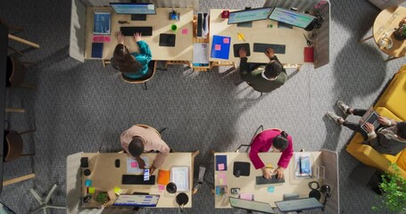 Leinwandbilder - Top Down View: Diverse Team of Professionals Working on Digital Projects in an Office. Businesspeople Analyze Data and Use Laptops. Creative Workspace With Charts, Infographics, and Discussions.