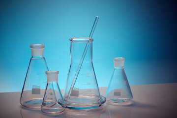 Sticker - Empty glass flasks placed in a  laboratory table