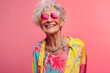 © milkyway - Joyful Retired Senior Woman in Vibrant Neon Clothes Exuding Confidence and Happiness