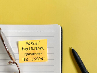 inspirational quote - forget the mistake remember the lesson on adhesive notepaper with copy space b