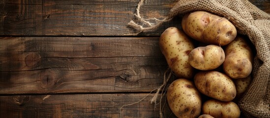 Wall Mural - Rustic Potatoes on Wooden Background