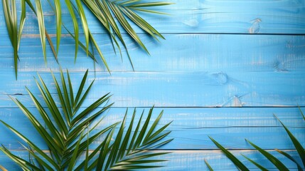 Wall Mural - Palm leaf composition on blue wooden background Summer theme with space for text