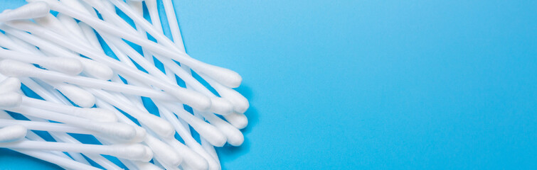 Plastic white cotton bud isolated on blue background, Plastic cotton swabs or cotton buds are on blue background, Plastic box with plastic white cotton bud with copy space.