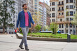 © Oscar - handsome man smiling and confident walking