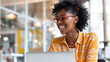 © pattozher - black businesswoman working with laptop and smiling at office