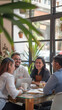 © Egoitz - A group of people are sitting around a table in a restaurant, smiling