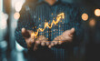 © Mahmud - Businessman business graph in hand on virtual screen. Planning and analyzing business and financial growth. Business incremental growth concept design