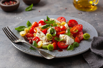 Wall Mural - healthy colorful tomato mozzarella basil salad with balsamic vinegar dressing