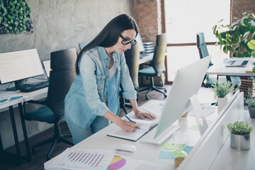 Poster - Photo of attractive young woman make notes writing dressed denim clothes executive business leader work comfort beautiful office interior