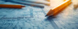 © Sudarshana - detailed closeup wide horizontal photo of yellow color drawing pencils on a architectural layout plan blueprint drawing on a table