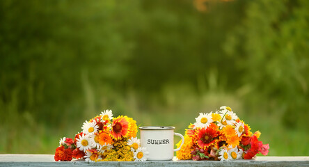 Wall Mural - white enamel mug with text Summer and colorful flowers on table in garden, natural background. summer season. rustic composition with flowers. relax time