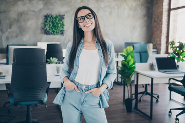 Wall Mural - Photo of dreamy good mood lady recruiter dressed denim jacket smiling working indoors workplace workstation loft