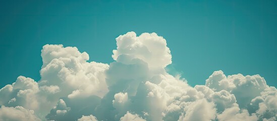 Poster - Clouds on a blue sky background create a serene nature scene in this copy space image.