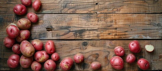 Aufkleber - A top view of red skinned potatoes on a wooden surface with a duplicated image in the center, featuring copy space.