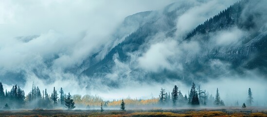 Wall Mural - Mountain landscape with copy space image featuring drifting low clouds.