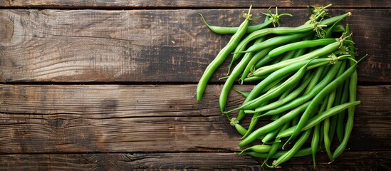 Canvas Print - Fresh green beans arranged on a rustic tabletop with a copy space image in the background, perfect for a healthy meal or snack.