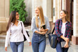 © Prostock-studio - Female students walking out of college building and chatting during break