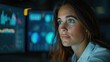 © Sunshine - A woman intently analyzing data on multiple computer screens in a modern office setting, highlighting technology and concentration.